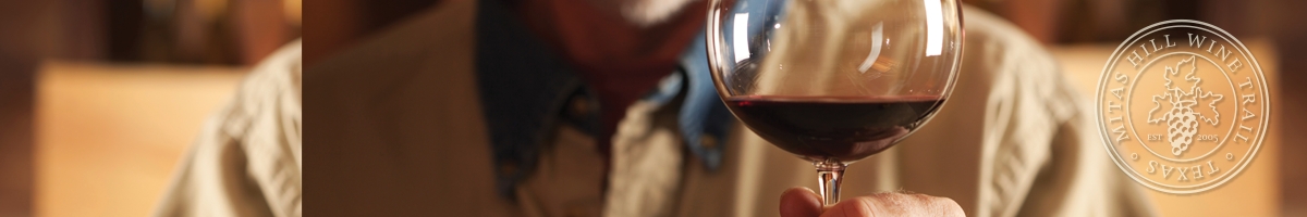 Picture of a chef swirling a glass of wine